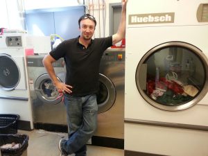 Jon Pell proudly displays an OPL laundry system we installed at a large veterinary clinic.