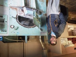 JD Dixon, president of National Laundry Equipment, standing next to an ancient washer extractor in a large hotel. They are so happy with their new machine-- and the savings from utilities! The 135# washer extractor will easily pay for itself in utilities savings over this dinosaur.